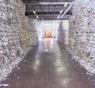 a warehouse filled with bales of shredded paper .
