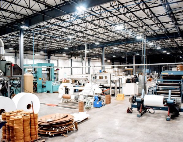 a large warehouse filled with lots of machinery and rolls of paper