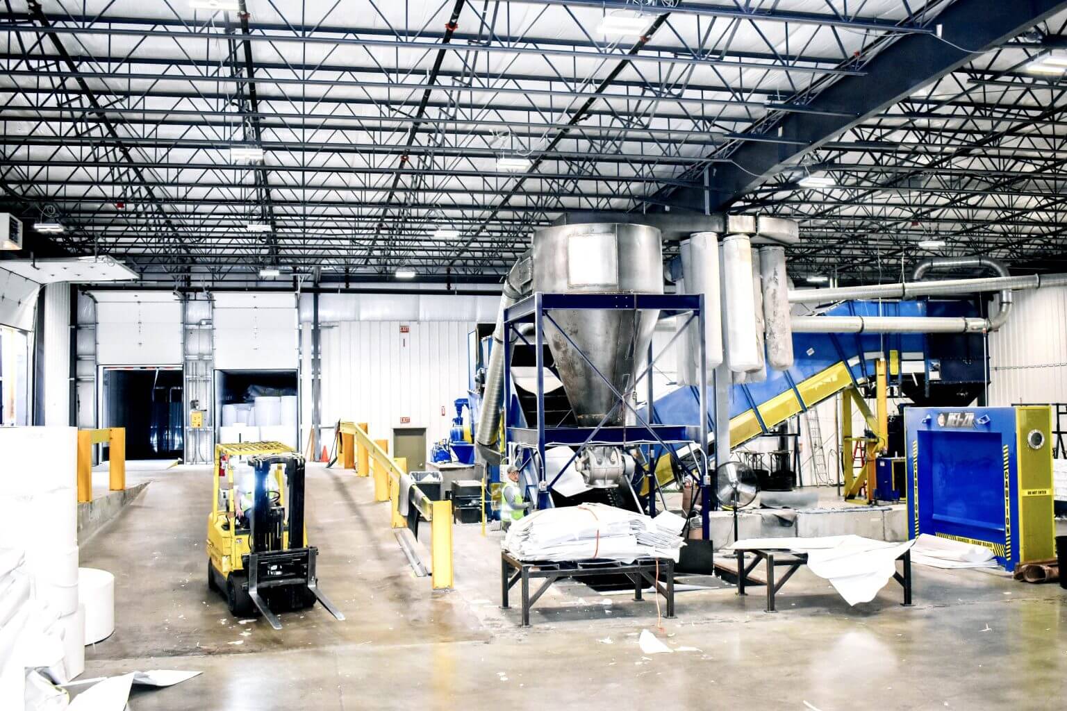 a yellow forklift is parked in a large warehouse